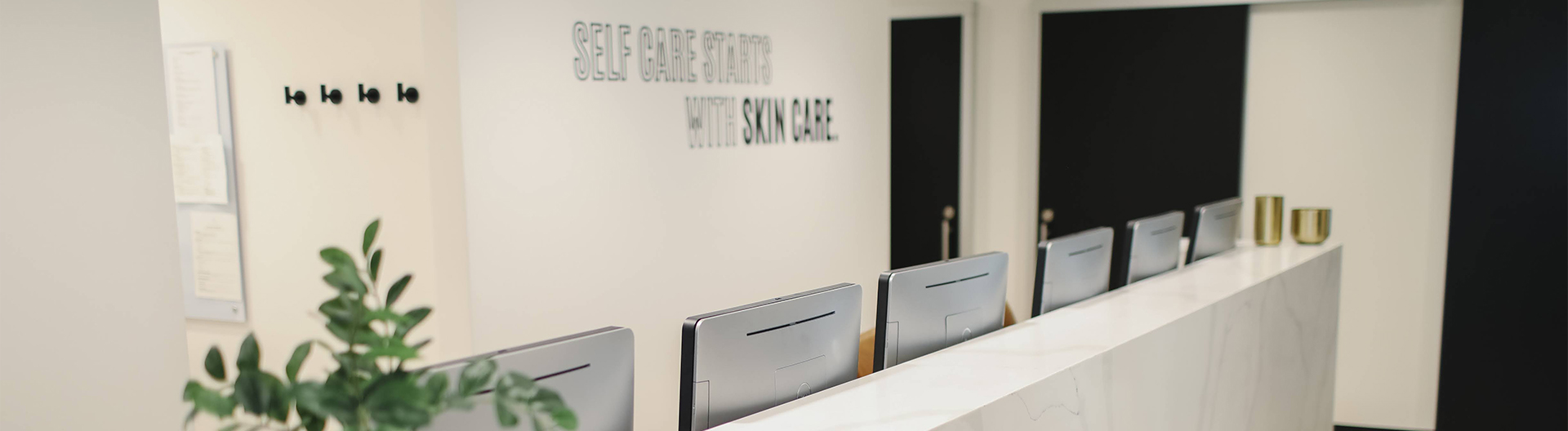 Office showing our self care starts with skin care sign