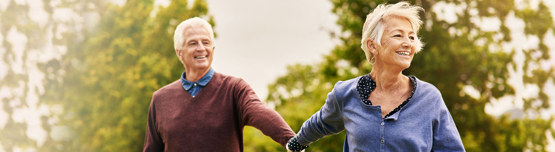 senior couple holding hands and smiling